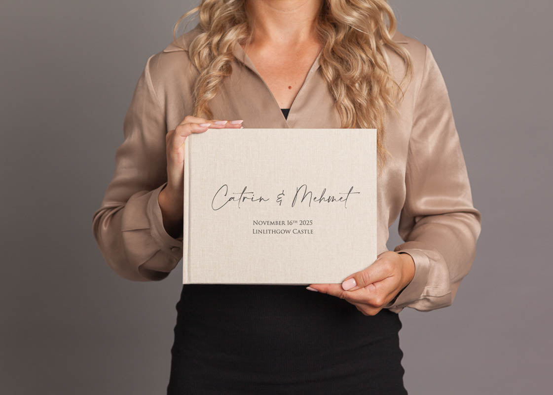 woman holding a wedding guest book